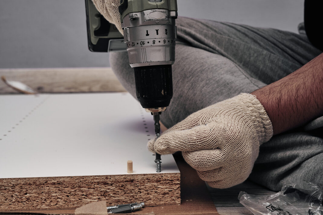 Furniture assembly process. Using a screwdriver during assembly. Do it yourself.