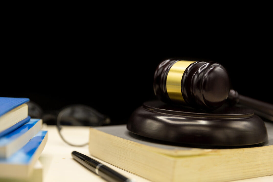 Judges gavel on book and wooden table. Law and justice concept b