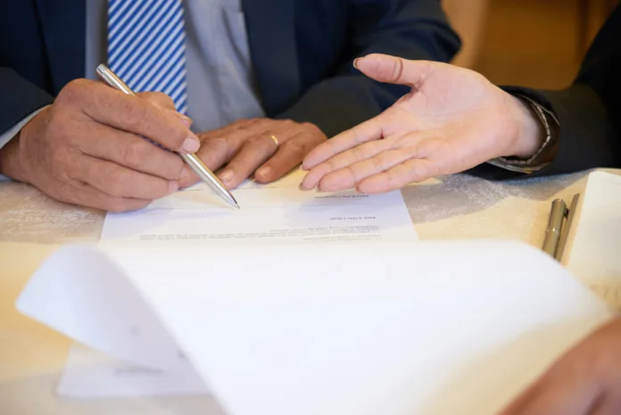 business-partners-signing-documents-2025-02-11-12-56-40-utc-696x465