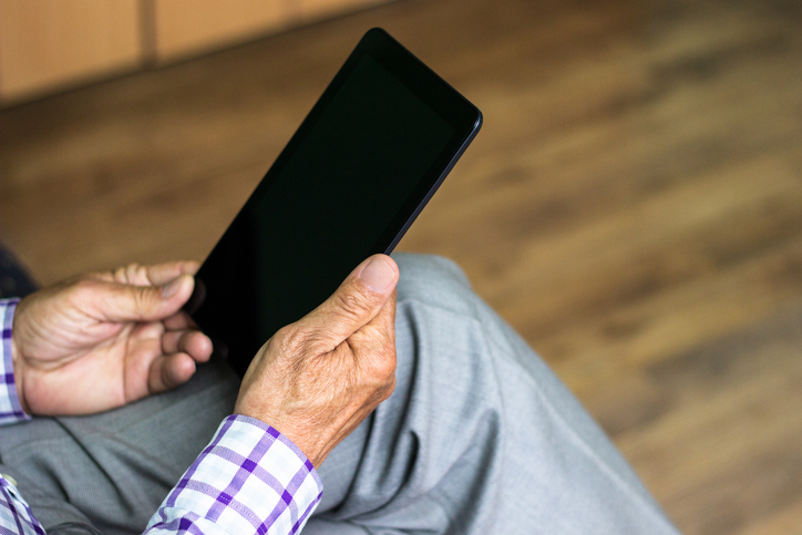 Senior using modern digital tablet